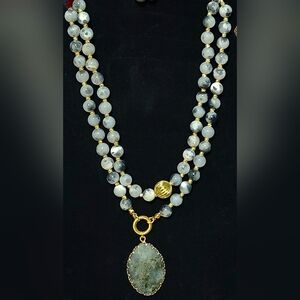 Beaded gemstone necklace featuring an oval pendant